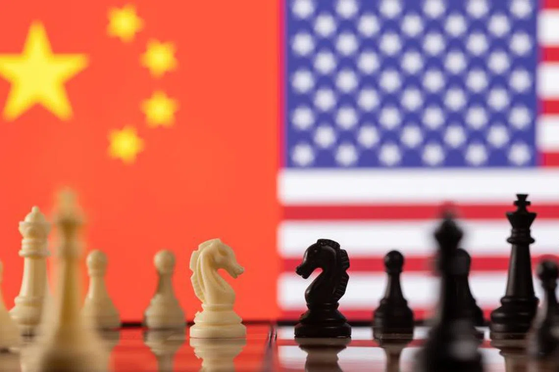 FILE PHOTO: Chess pieces are seen in front of displayed China's and U.S. flags in this illustration taken January 26, 2022. REUTERS/Dado Ruvic/Illustration/File Photo