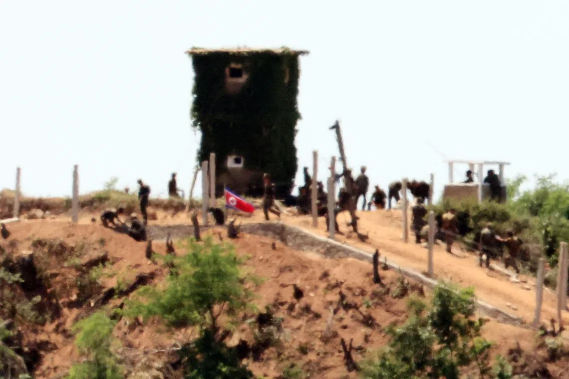 North Korean soldiers build a strongpoint in the Demilitarized Zone in June 4.