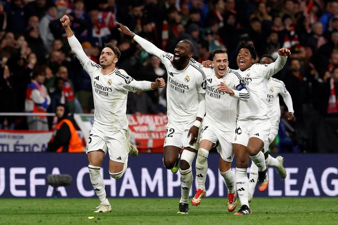 Real Madrid's Antonio Rudiger, Lucas Vazquez and Endrick celebrate after the match. 