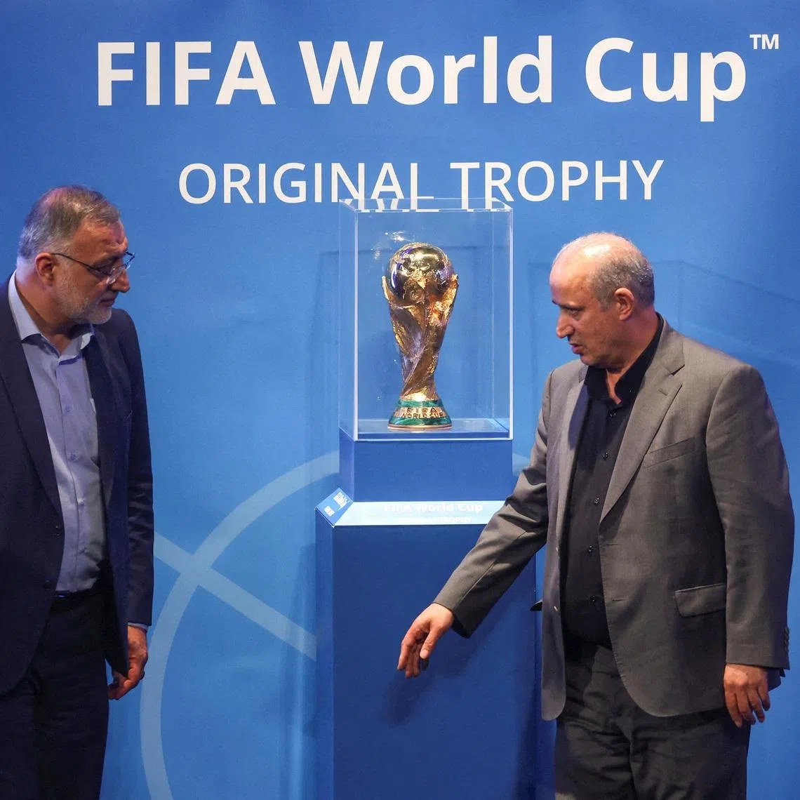 FILE PHOTO: President of Iran Football Federation Mehdi Taj and Mayor of Tehran Alireza Zakani stand next to the FIFA World Cup Trophy during an unveiling ceremony in Tehran, Iran September 1, 2022.  Majid Asgaripour/WANA (West Asia News Agency) via REUTERS ATTENTION EDITORS - THIS IMAGE HAS BEEN SUPPLIED BY A THIRD PARTY./File Photo
