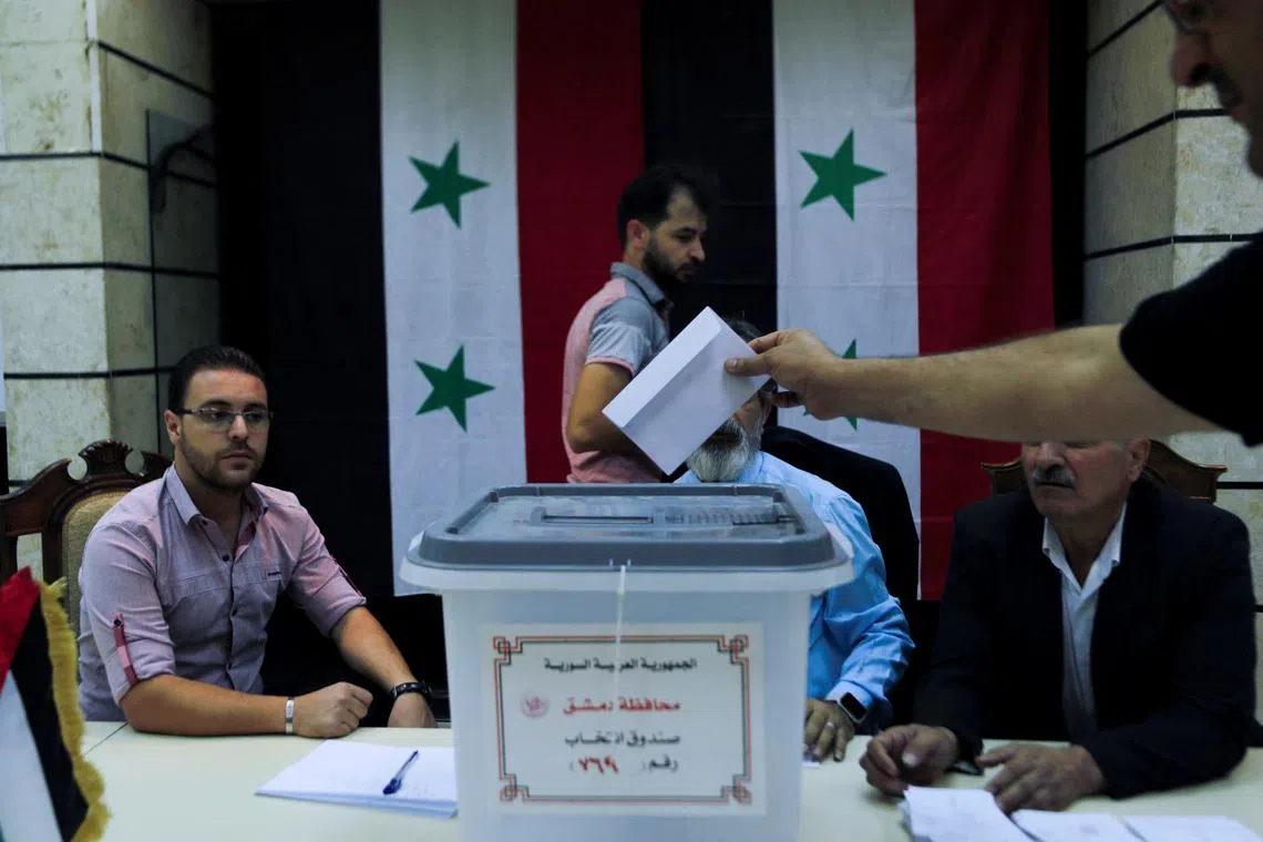 FILE PHOTO: A man casts his ballot at a polling station during parliamentary elections, in Damascus, Syria July 15, 2024. REUTERS/Yamam al Shaar/File Photo