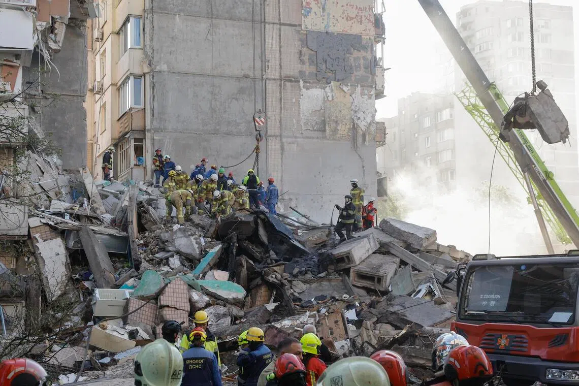 Ukrainian rescuers dug through the debris of a residential building gutted in the attack.