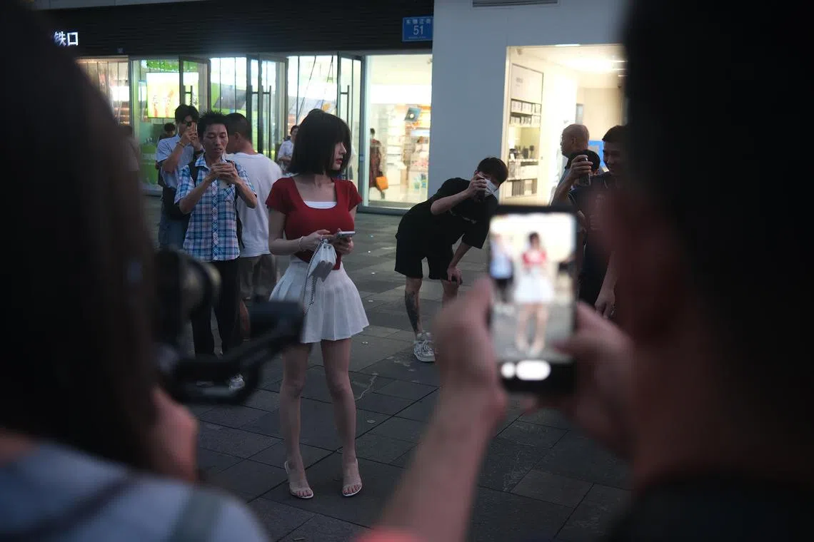 awphoto - Videographers and photographers station themselves at trendy shopping areas in China’s busiest cities, including Beijing, Shanghai and Chengdu, as part of the country's “jie pai” or street-snapping trend to capture the country’s fashionistas and influencers - an endeavour that may appear to be organic but can also be highly orchestrated. When The Straits Times visited Yuanyang Taikooli over two evenings in June, shutterbugs in Sichuan’s provincial capital and south-western China’s most developed city went into a frenzy after they spotted at least two influencers - with 2.6 million followers each - in the shopping district.

Copyright: Aw Cheng Wei