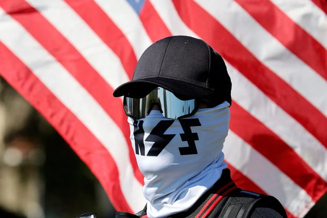 FILE PHOTO: A member of the white nationalist group NatSoc Florida protests against U.S. support for Israel, in response to the war between Israel and Hamas, in Lady Lake, Florida, U.S., October 21, 2023. REUTERS/Joe Skipper/File photo