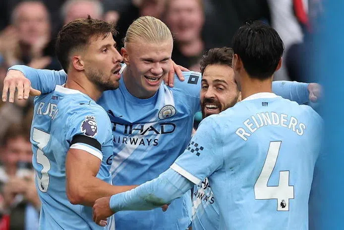 Manchester City's Erling Haaland (centre) celebrates with his teammates after the match.