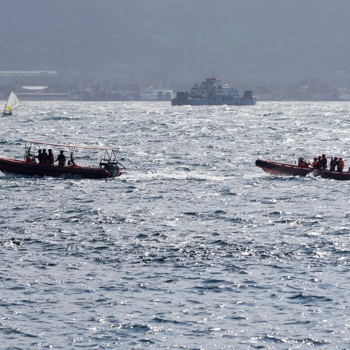 Indonesia rescue team members sail on dinghies during a search operation for missing passengers, after the KMP Tunu Pratama Jaya ferry carrying 65 people sank near the Indonesian island of Bali, in Bali, Indonesia, July 3, 2025. REUTERS/Johannes P. Christo