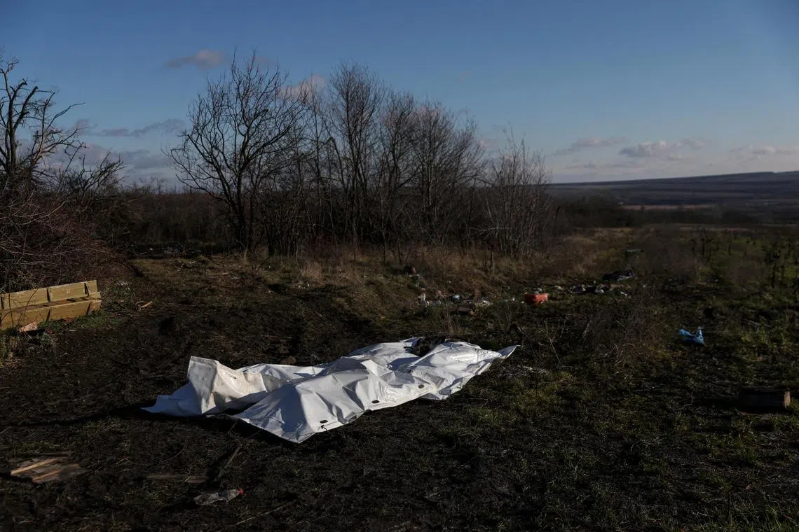 The bodies of dead Russian soldiers lay covered after being gathered by Ukrainian soldiers, to be exchanged for the bodies of fallen Ukrainian soldiers, as Russia's attack on Ukraine continues, in the former Russian occupied region of Donetsk Oblast, Ukraine. 