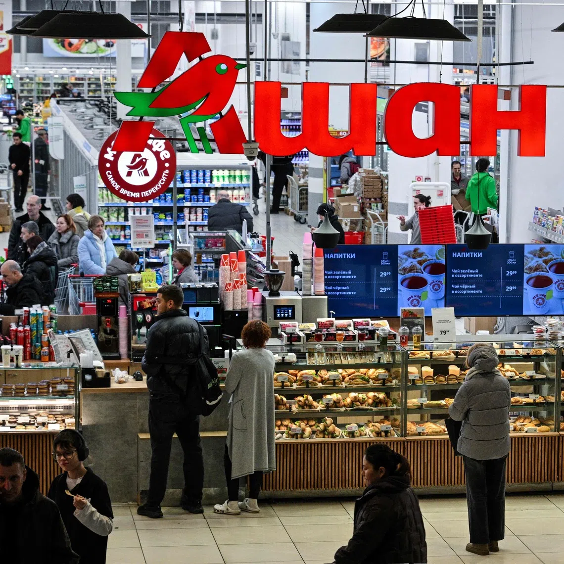 Customers shopping in an Auchan supermarket in Moscow. The Russian authorities have seized the assets of Swiss food giant Nestle and three French groups in response to Western sanctions.