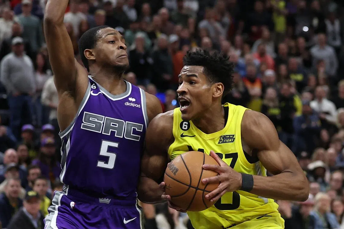 Utah Jazz guard Ochai Agbaji drives against Sacramento Kings guard De'Aaron Fox in the fourth quarter at Vivint Arena.