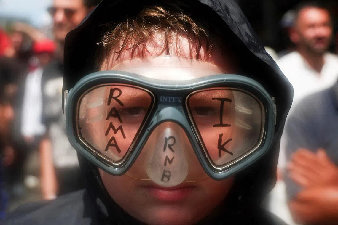 A protester wears a diving mask reading "Rama go away" during a demonstration against the government, following weeks of protests against a planned luxury resort backed by a company linked to Jared Kushner, the son-in-law of U.S. President Donald Trump, on an environmentally sensitive part of the Adriatic coast, in Tirana, Albania, July 23, 2026. REUTERS/Florion Goga TPX IMAGES OF THE DAY