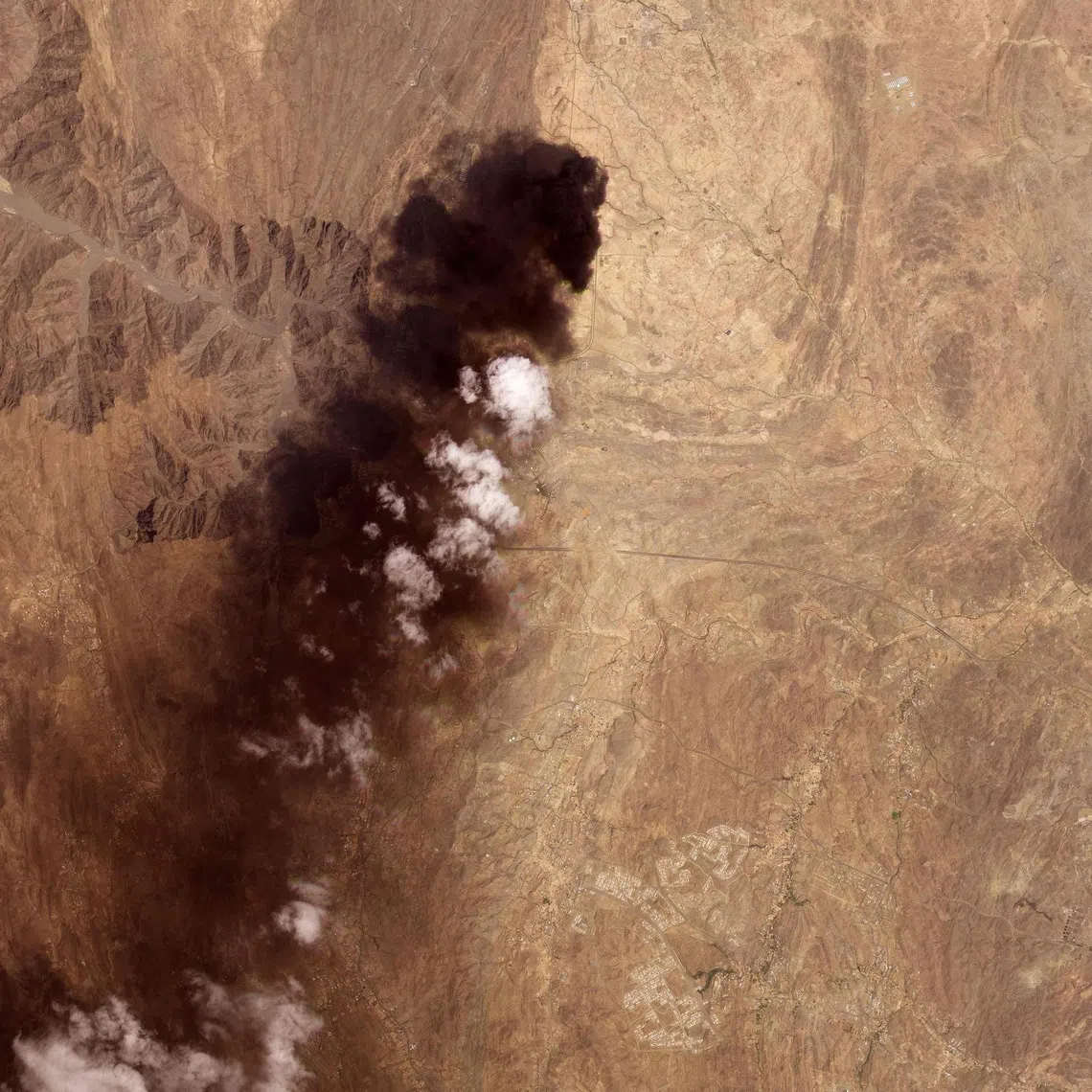 A satellite image taken by Planet Labs PBC on Sept 8 showing smoke billowing from an Aramco oil depot near the Saudi city of Abha following a Houthi attack.