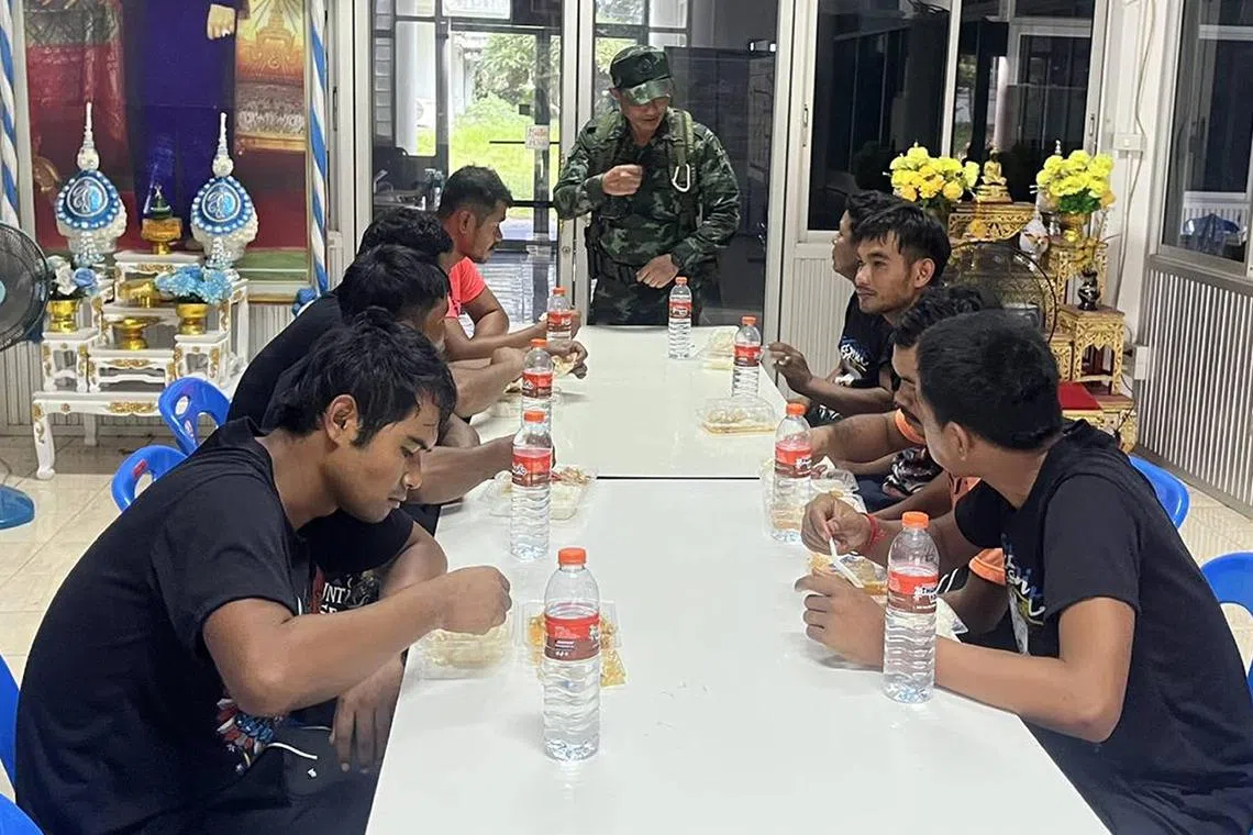 Cambodian soldiers detained by Thai military having their meals on July 29. Cambodia said on July 31 that talks were under way for the release of 20 soldiers.