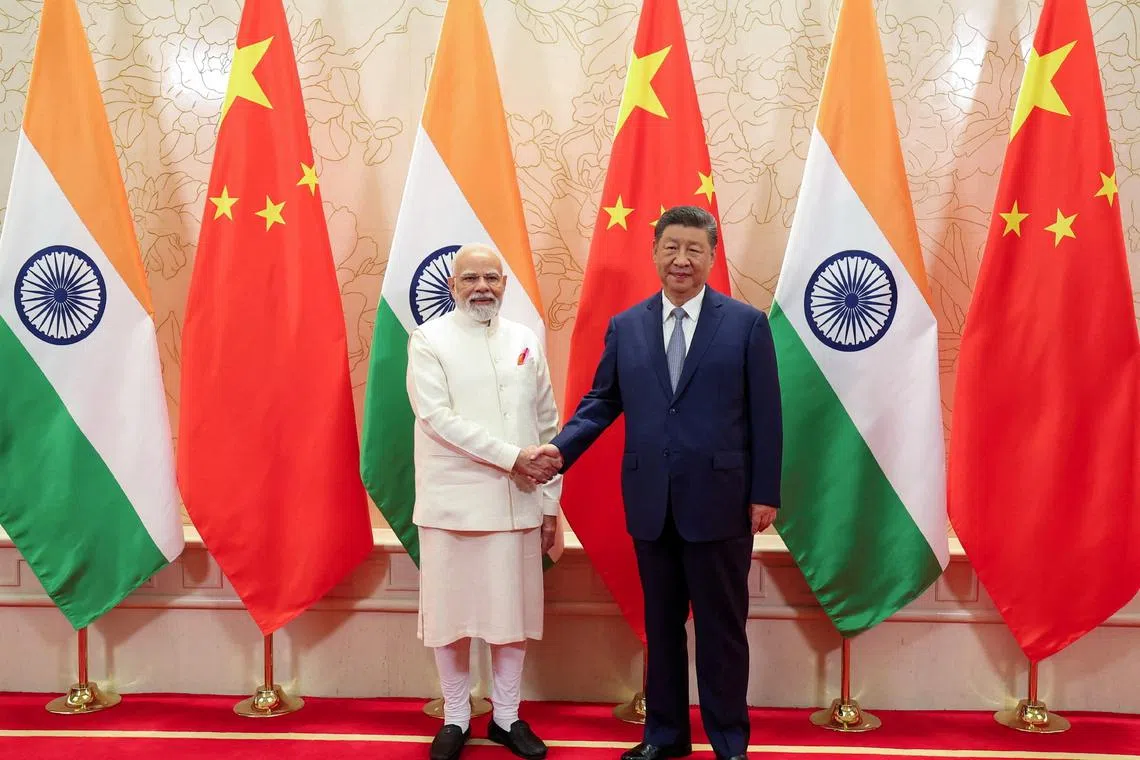 India’s Prime Minister Narendra Modi (left) shakes hands with Chinese President Xi Jinping in Tianjin on Aug 31.