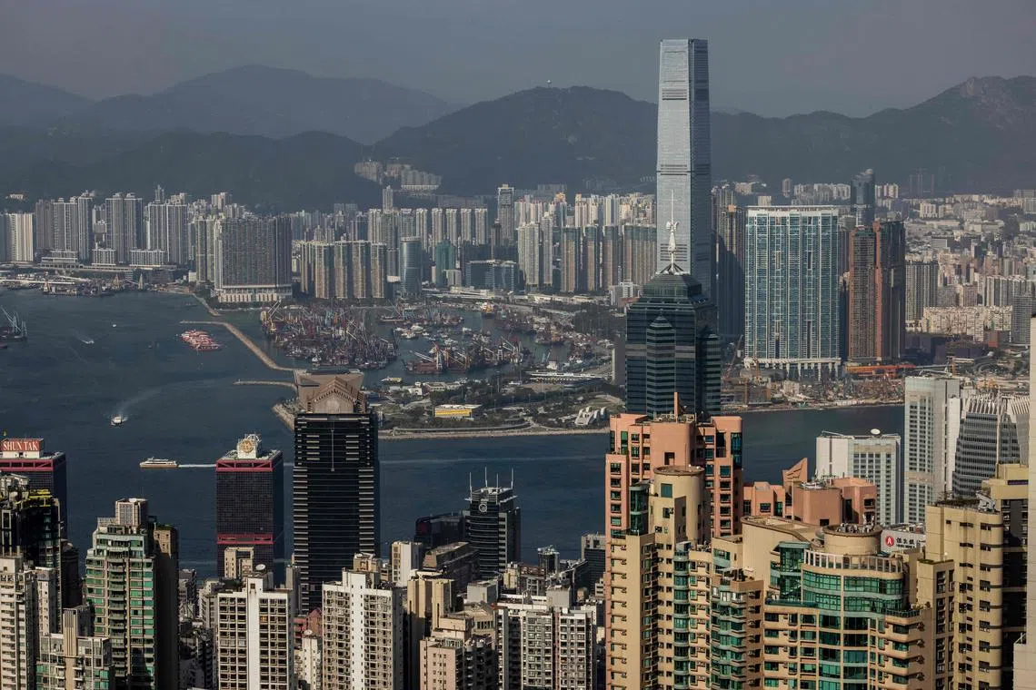 Commercial and residential buildings are pictured in Hong Kong on January 27, 2023. (Photo by ISAAC LAWRENCE / AFP)