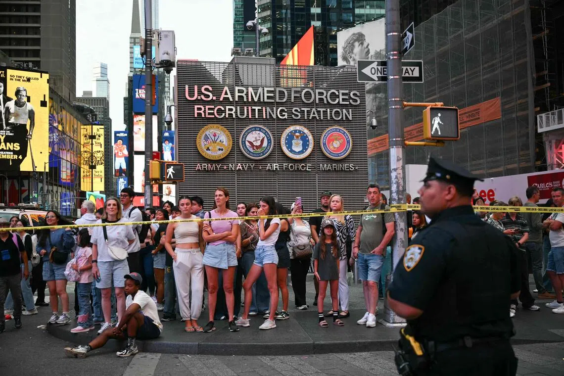 People looking on at the scene of the stabbings in New York’s Times Square on Aug 31. According to ABC7 New York, a woman stabbed two people before confronting police.