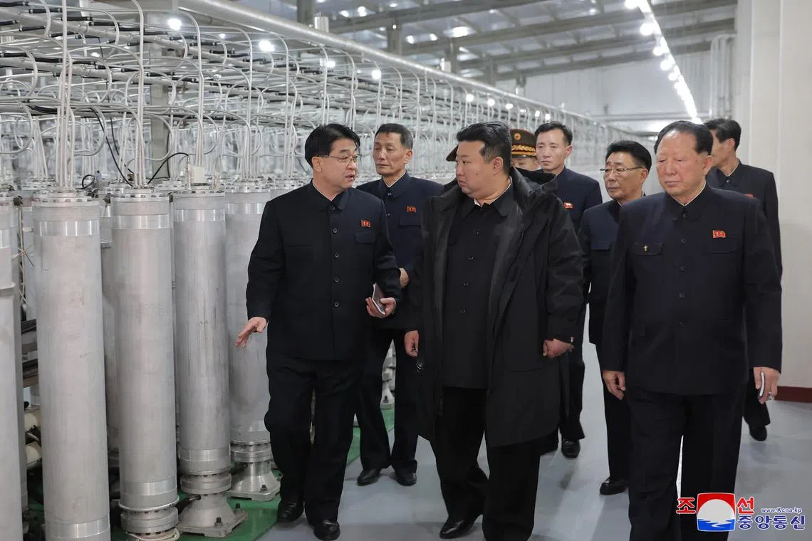 North Korean leader Kim Jong Un (right) inspecting a nuclear material production base on Jan 29.
