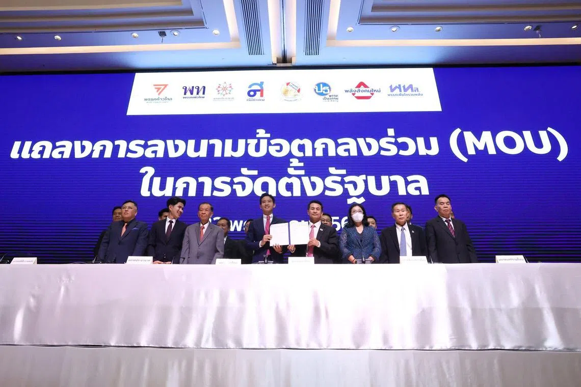 Pita Limjaroenrat, leader of the Move Forward Party, center, poses for a photograph during a meeting of coalition parties in Bangkok, Thailand, on Monday, May 22, 2023. Thailand’s pro-democracy parties signed a pact to form the country’s next government after a historic win in the May 14 election, a step seen crucial to gather support for Move Forward’s Pita Limjaroenrat to become prime minister. Photographer: Valeria Mongelli/Bloomberg