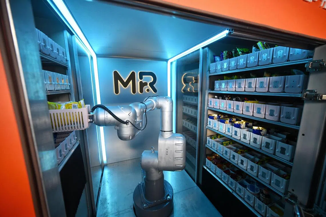 The robotic arm inside the Unistop robotic convenience kiosk on June 17, 2025.

ST PHOTO: AZMI ATHNI