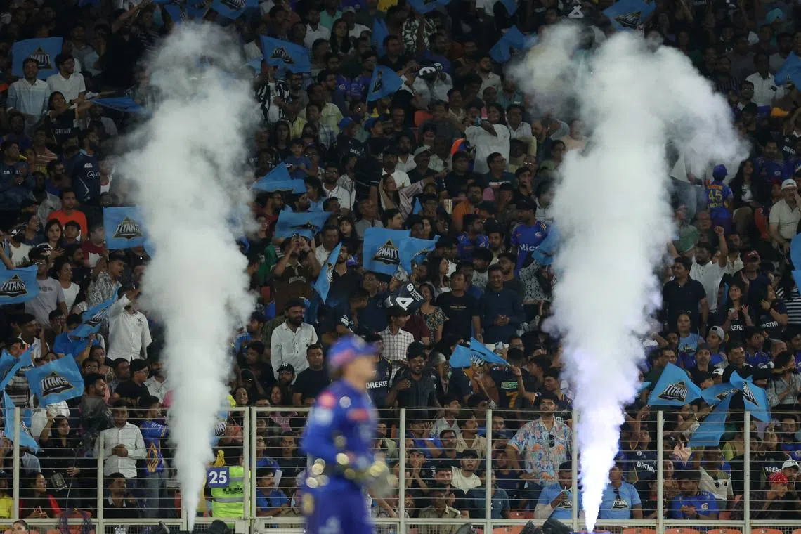 FILE PHOTO: Cricket - Indian Premier League - IPL - Gujarat Titans v Mumbai Indians - Narendra Modi Stadium, Ahmedabad, India - March 29, 2025 Gujarat Titans fans celebrate six runs scored by Jos Buttler REUTERS/Amit Dave/File Photo