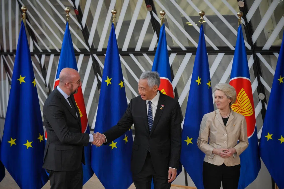PM Lee Hsien Loong (centre) greets European Council President Charles Michel (left) and European Commission President Ursula von der Leyen, during the Asean-EU summit in Brussels, on Dec 14, 2022.