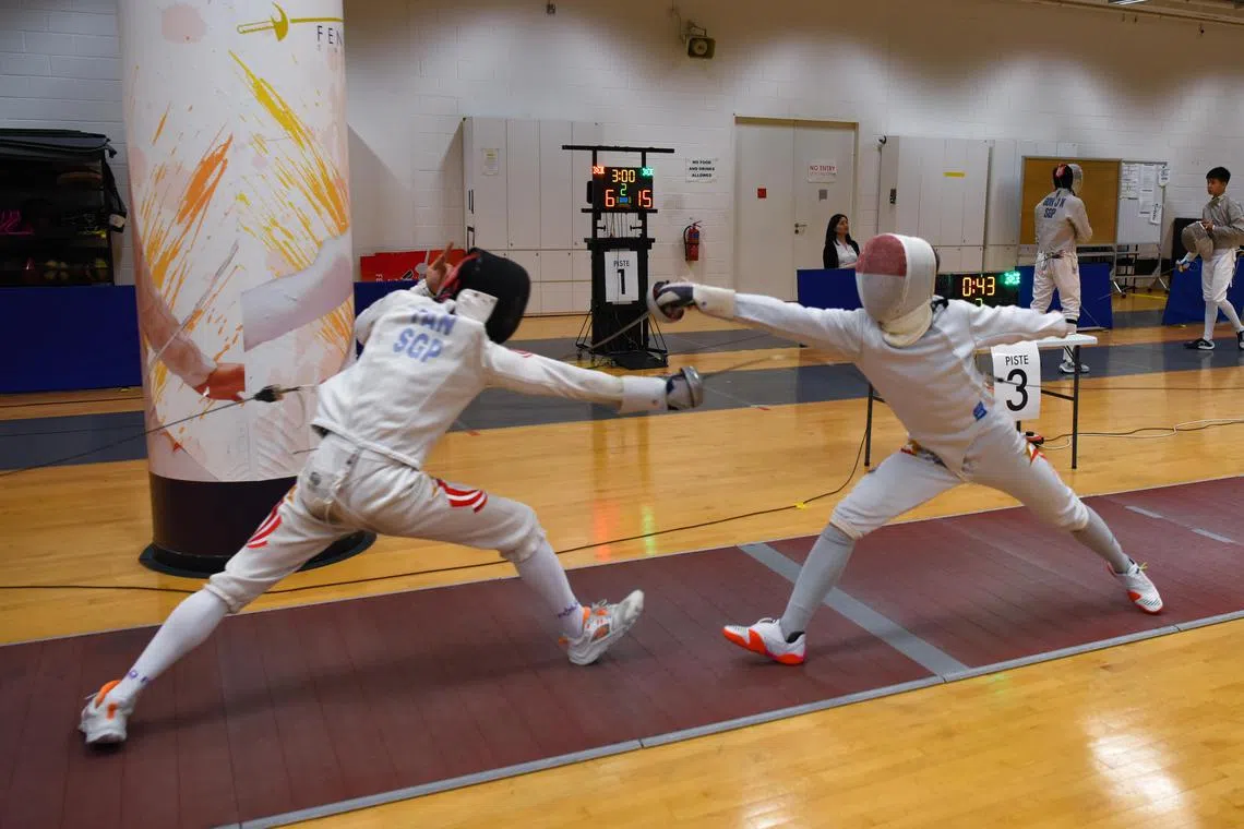 From left, Singapore Sports School student, Tan Yun Kai, 17, and Anglo-Chinese School (International) student, Samuel Robson,17, facing off in the A division fencing boys' epee finals on April 20, 2023.