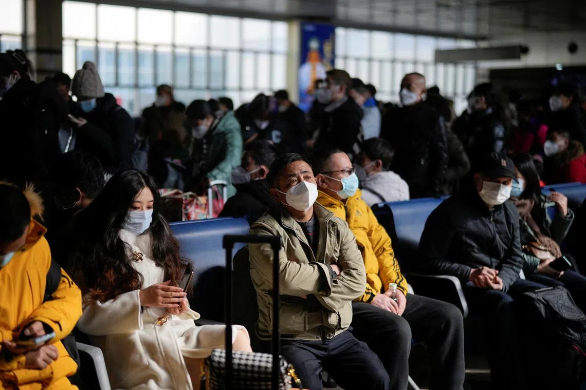 People waiting to board a train at a railway station during the annual Spring Festival travel rush in Shanghaion Jan 16, 2023.