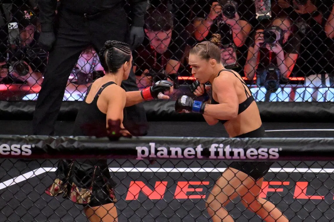 May 16, 2026; Los Angeles, California, USA;  Ronda Rousey (blue gloves) fights Gina Carano (red gloves) in a women's featherweight bout at Intuit Dome. Mandatory Credit: Jayne Kamin-Oncea-Imagn Images