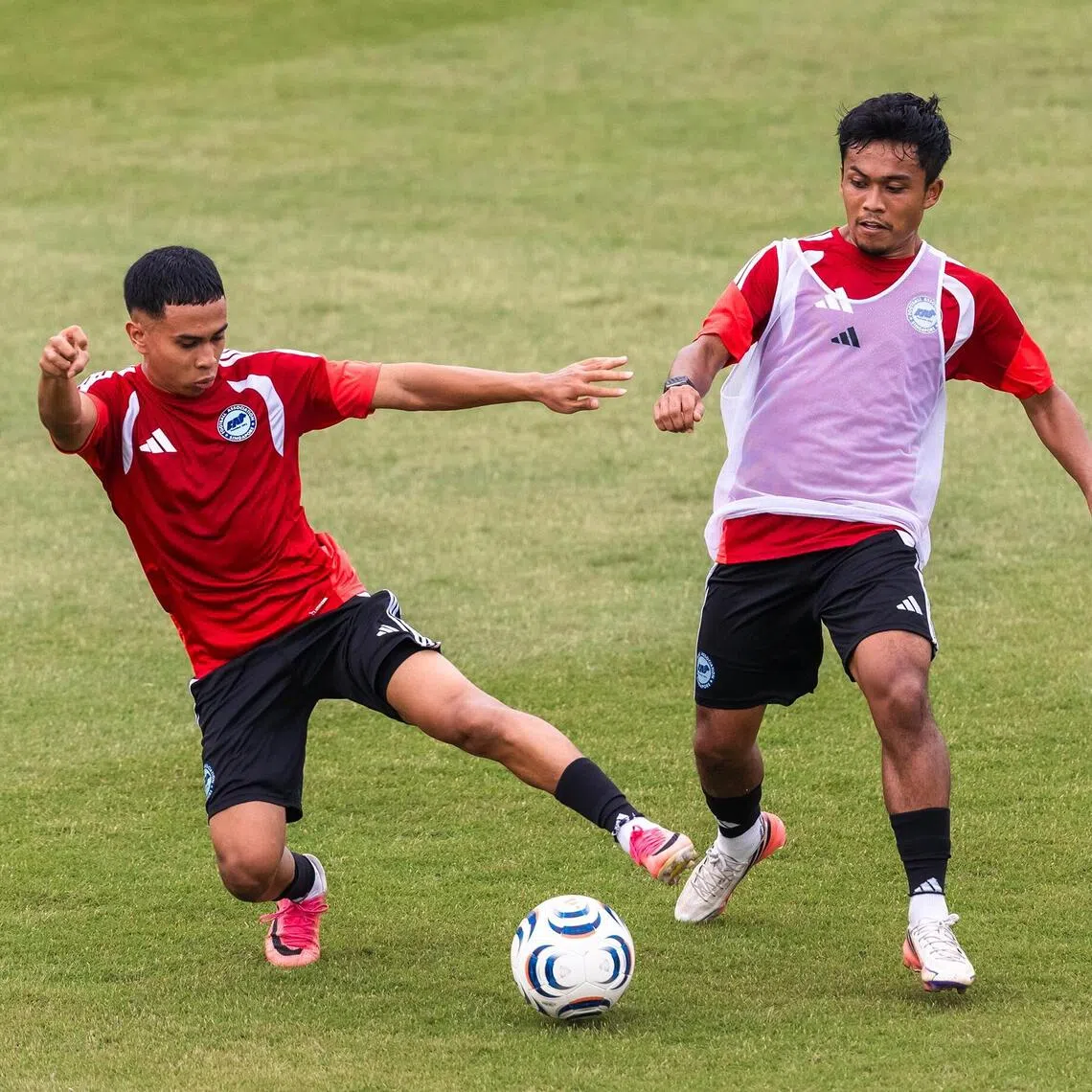 Farhan Zulkifli (left) challenging for the ball against Hami Syahin during the Lions’ training session on Sept 22.