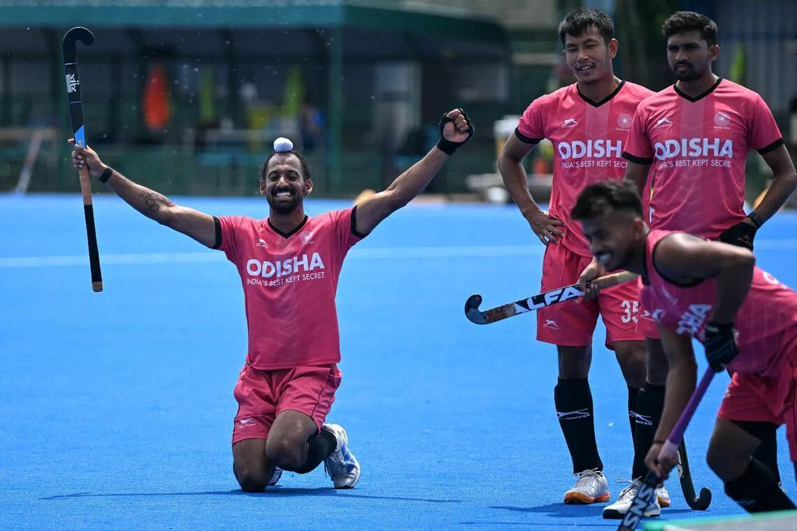 Hardik Singh (left) of the Indian men’s national hockey team cheering with teammates during a practice session at the Sports Authority of India (SAI) centre in Bengaluru.