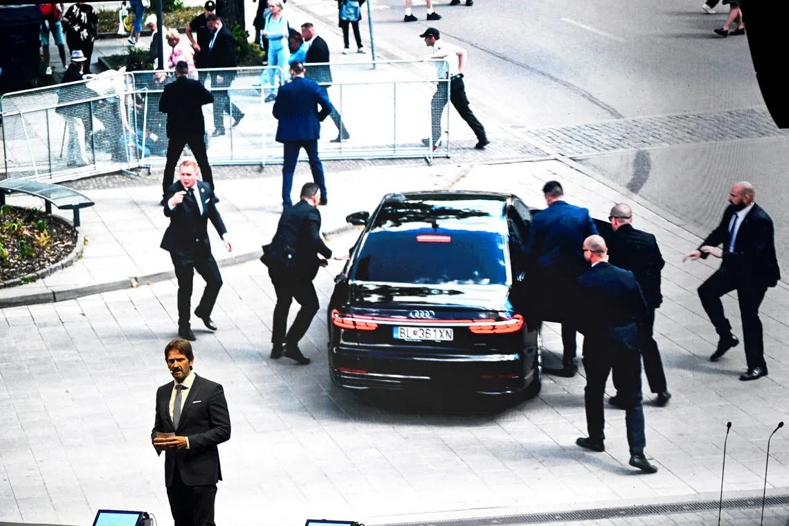 FILE PHOTO: Slovak Defence Minister Robert Kalinak speaks in front of a screen displaying an image from the attempted assassination of Slovakia's Prime Minister Robert Fico, during a SMER-SSD party's rally, in Handlova, central Slovakia May 15, 2025. REUTERS/Radovan Stoklasa/File Photo