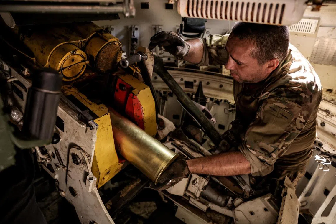 A Ukrainian serviceman loading an ammunition shell into a self-propelled howitzer, near the town of Chasiv Yar in Ukraine's Donetsk region, on June 22.