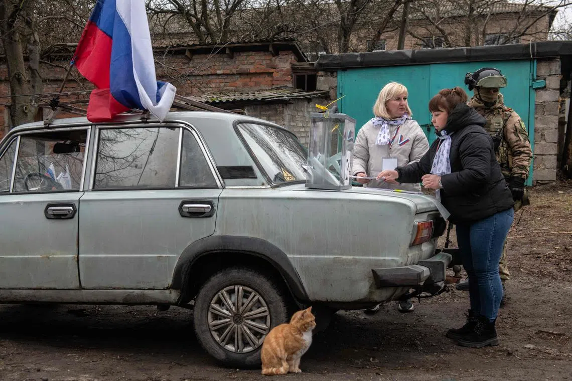 Members of a local election commission, accompanied by a serviceman, preparing a mobile polling station during early voting in Russia's presidential election in Donetsk, amid the Russia-Ukraine conflict on March 14, 2024. 