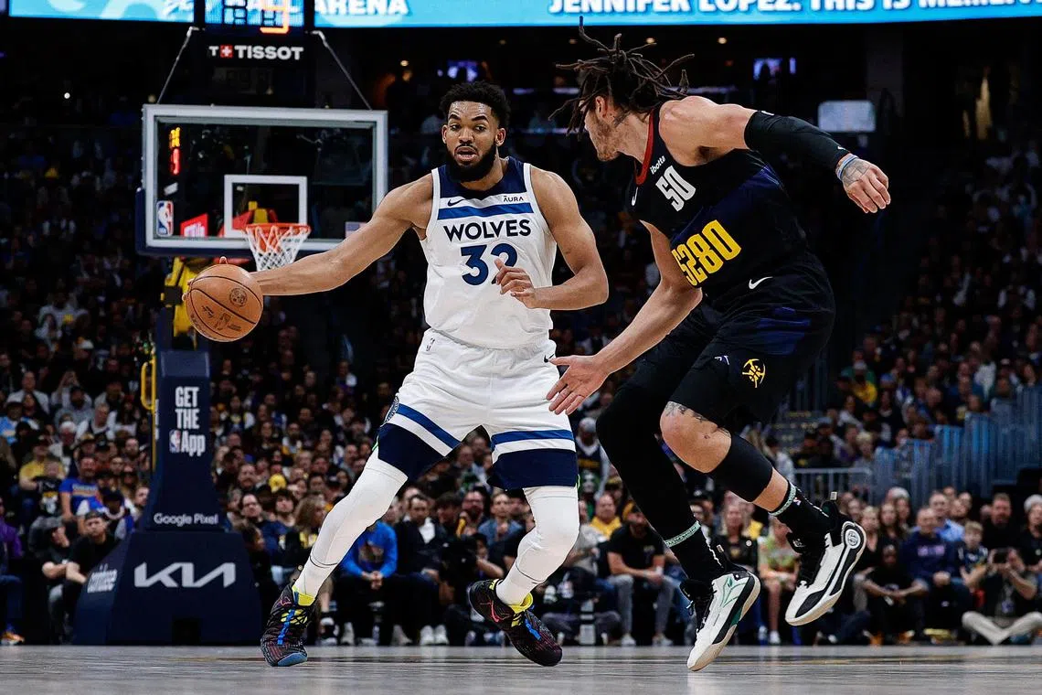 Minnesota Timberwolves centre Karl-Anthony Towns controls the ball as Denver Nuggets forward Aaron Gordon guards in the first quarter of Game 2 of the NBA Western Conference semi-finals.