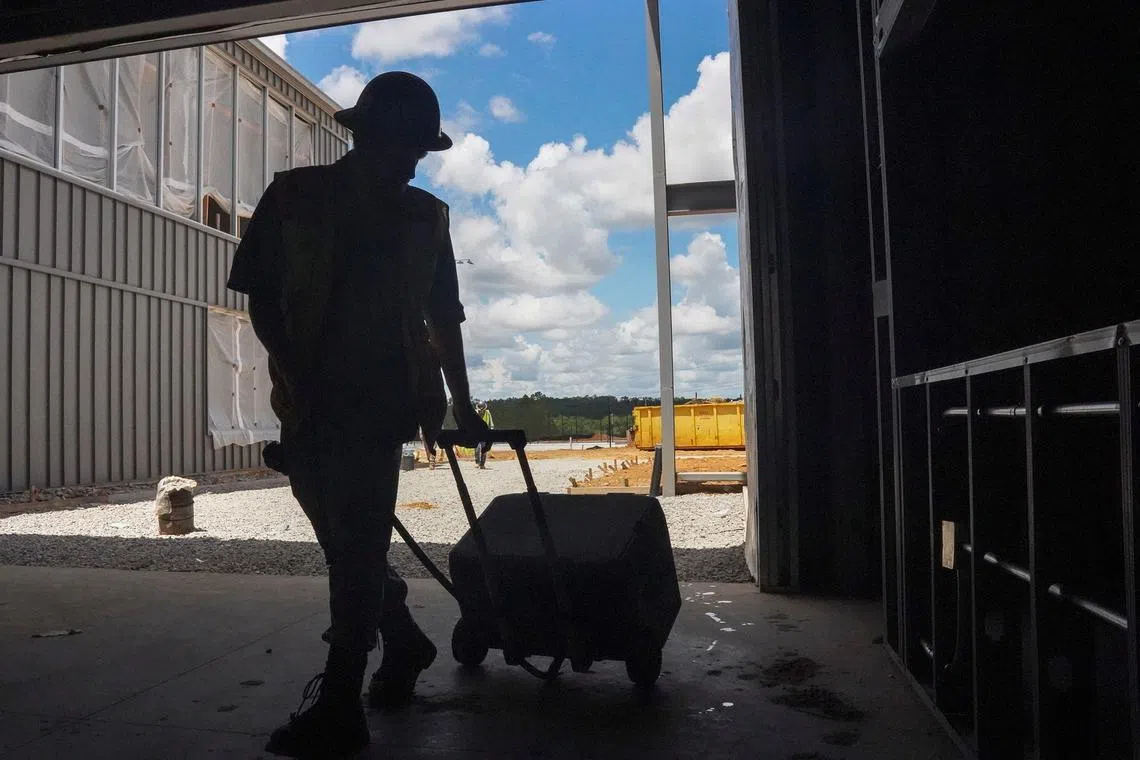 FILE PHOTO: A man works at a construction site facing shortages of migrant workers due to the pace of immigration-related raids in the region, near Mobile, Alabama, U.S., July 14, 2025. REUTERS/Megan Smith/File Photo