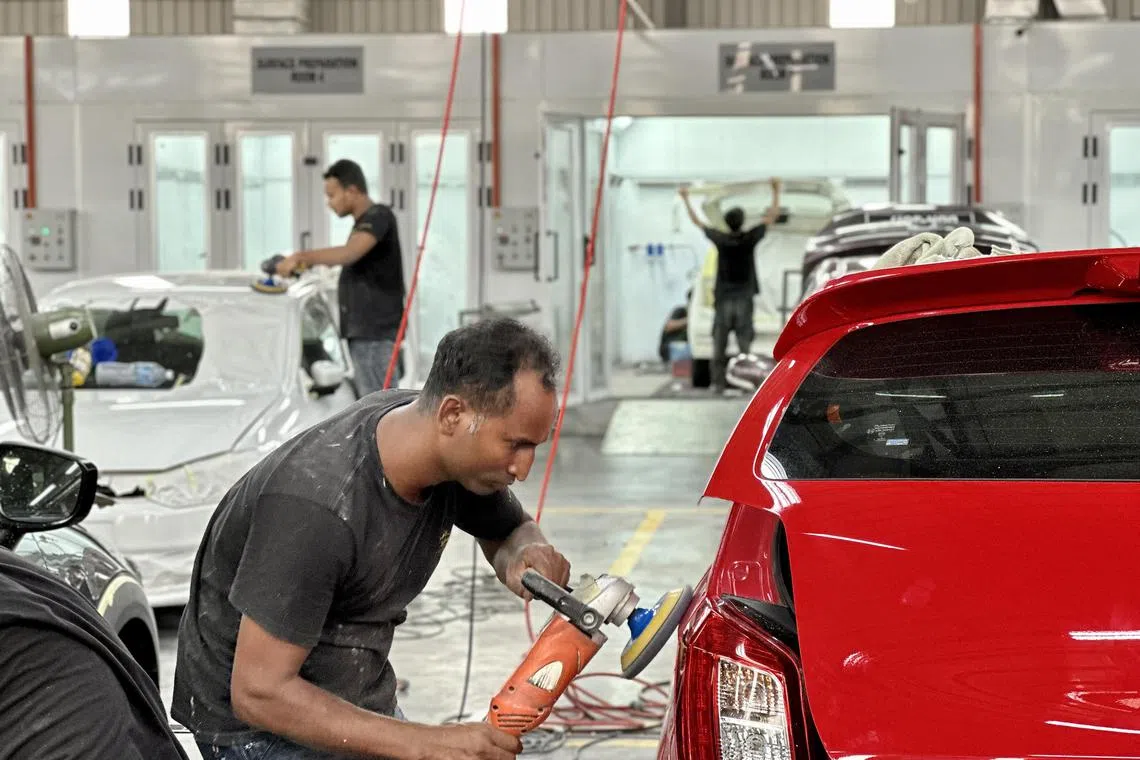 stcar - Workers putting the finishes touches on reconditioned cars before they find new homes. 

Photo: Shannon Teoh