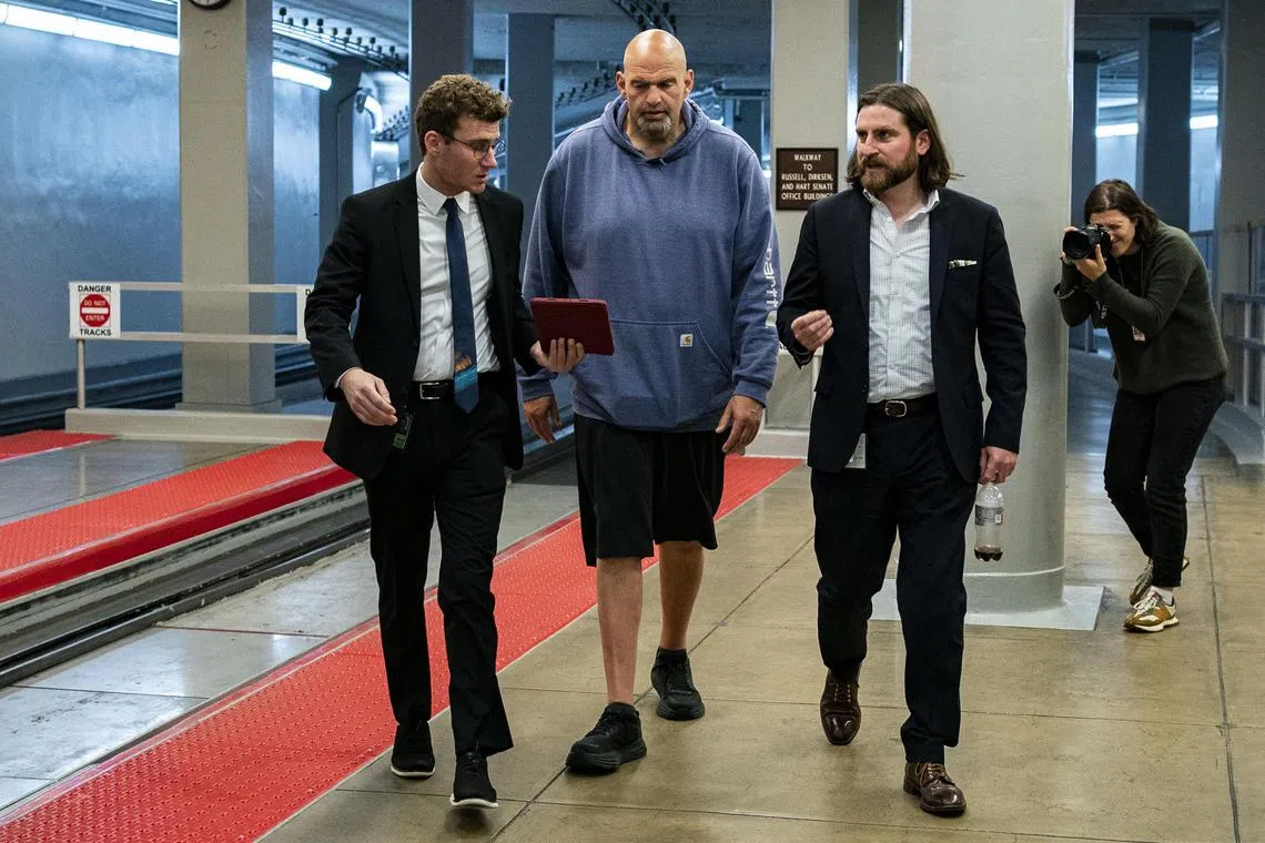 Democratic Senator John Fetterman speaks to reporters ahead of a Senate vote on Capitol Hill.