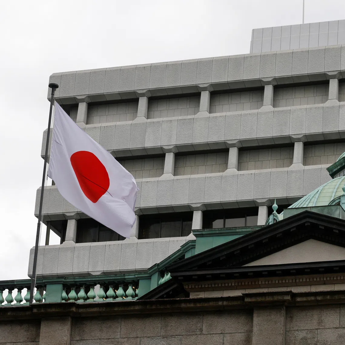 A Japanese flag flutters atop the Bank of Japan headquarters in Tokyo, Japan, on Sept 18, 2026.