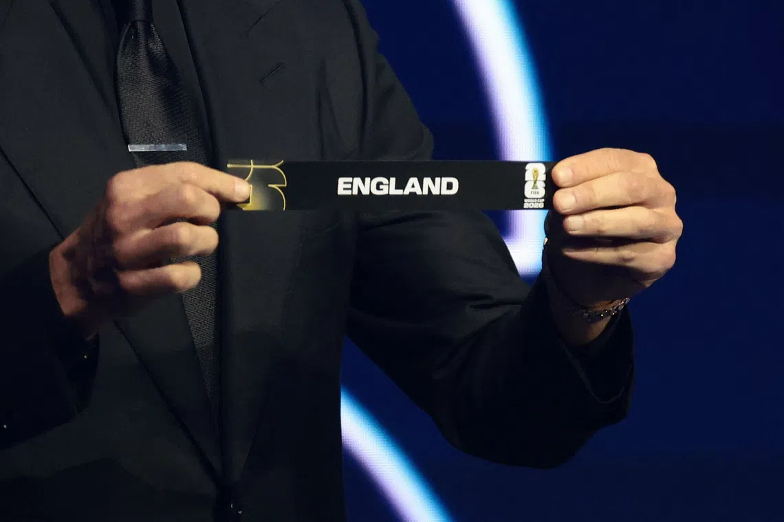 Soccer Football - FIFA World Cup 2026 - FIFA World Cup 2026 Draw - John F. Kennedy Center for the Performing Arts, Washington, D.C., U.S. - December 5, 2025 Draw Assistant Tom Brady draws England during the draw REUTERS/Evelyn Hockstein