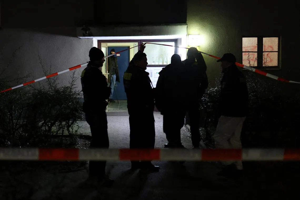 German police officers guard the entrance of a building where Daniela Klette, a 65-year-old alleged member of Germany's notorious Red Army Faction (RAF) militant group, has been arrested after decades on the run from armed robbery and attempted murder charges, in Berlin, Germany, February 28, 2024. People have been evacuated from the building after explosives were found, according to police. REUTERS/Christian Mang