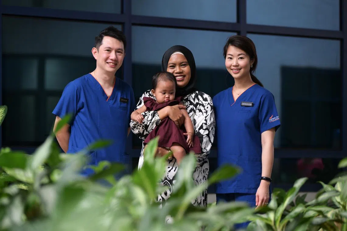 Dr Ee Tat Xin (left) and senior consultant Felicia Chin (right) with their patient Ms Yuana Kamsani and her baby Erza Tania binte Mohammed Shaiful. 