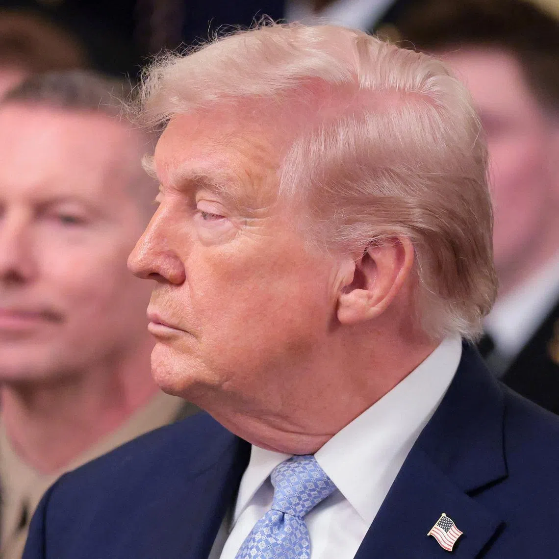 U.S. President Donald Trump looks on during a presentation of the Commander-in-Chief's trophy to the U.S. Navy Midshipmen football team of the United States Naval Academy, at the White House in Washington, D.C., U.S., March 20, 2026. REUTERS/Kylie Cooper