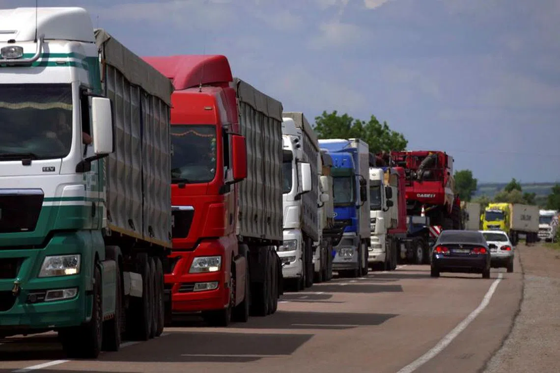 Trucks with grain wait for crossing the Ukraine-Moldova border in Odesa region, as Russia's attack on Ukraine continues, Ukraine June 11, 2022.  REUTERS/Igor Tkachenko/File Photo