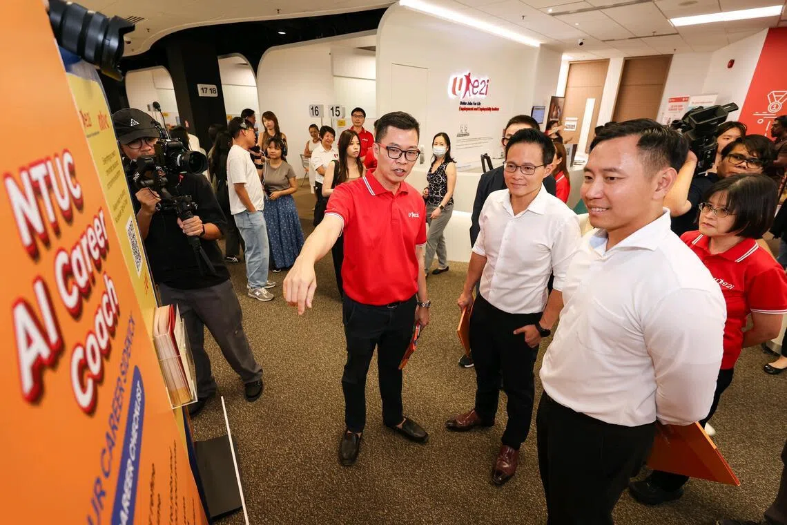 (From left) Mr Justin Ting, 54, e2i career coach, giving Mr Desmond Choo, NTUC deputy secretary-general, and Mr Goh Pei Ming, Minister of State for Education and Social and Family Development, a tour of the career centre during the Economic Strategy Review Committee media visit at the Devan Nair Institute for Employment and Employability on Feb 9, 2026. ST PHOTO: BRIAN TEO