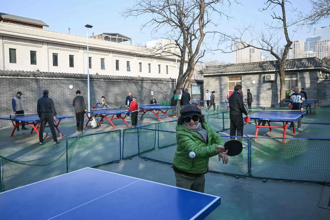 People play table tennis at Ritan Park in Beijing on Feb 4