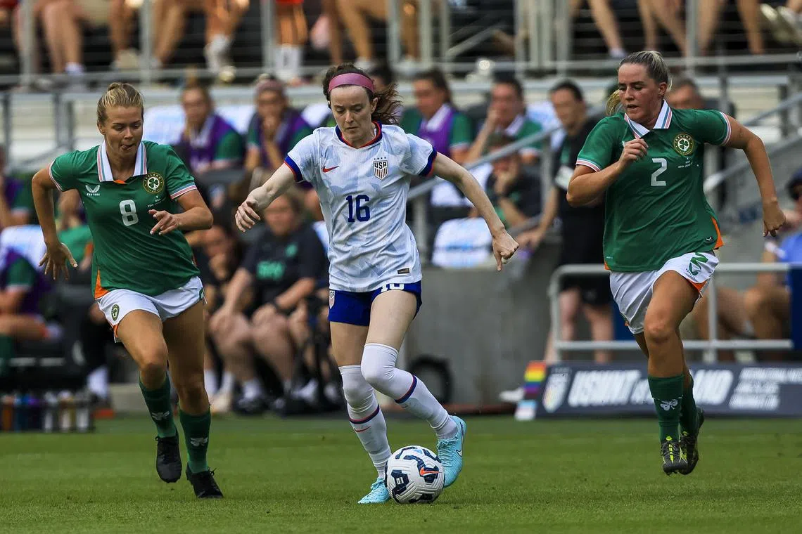 Jun 29, 2025; Cincinnati, Ohio, USA; United States midfielder Rose Lavelle (16) dribbles against Ireland midfielder Ruesha Littlejohn (8) and defender Jessie Stapleton (2) in the second half at TQL Stadium. Mandatory Credit: Katie Stratman-Imagn Images