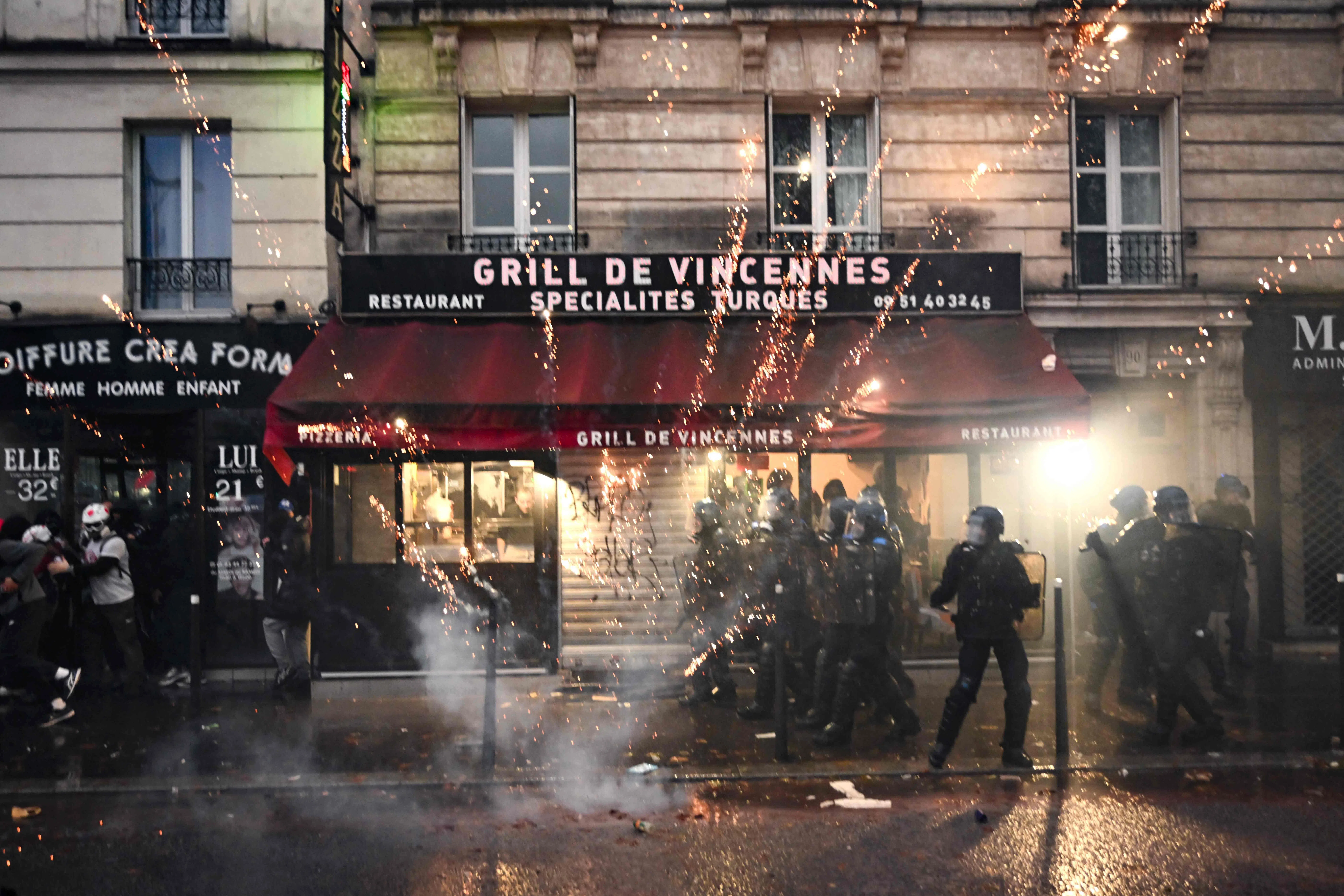 Police officers clash with protesters near Porte de Vincennes in Paris.