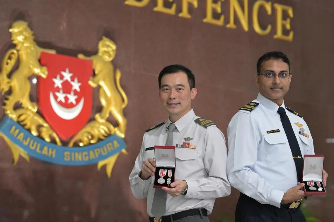 ME6 William Teo (left), Head Threat Hunting Centre, DIS and ME6 Sathananthar Suresh, Airforce Engineer and Deputy Commanding Officer 110 SQN, RSAF with their Long Service Medal.
