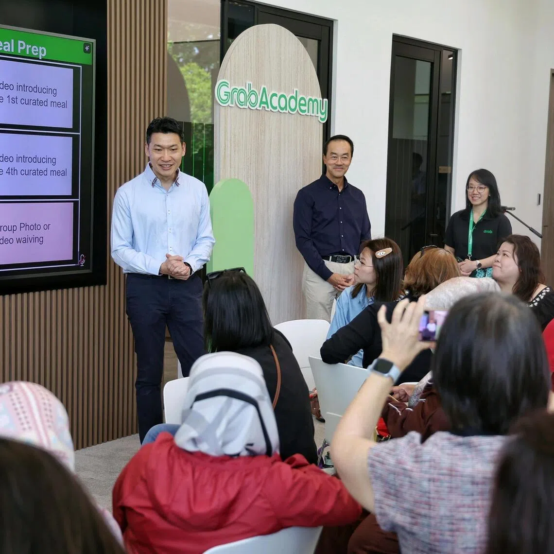 Acting Minister for Culture, Community and Youth and Senior Minister of State for Education David Neo and Senior Minister of State for Manpower and Health Koh Poh Koon interacting with female Grab partners during an AI upskilling workshop conducted by GrabAcademy on Feb 5, 2026.