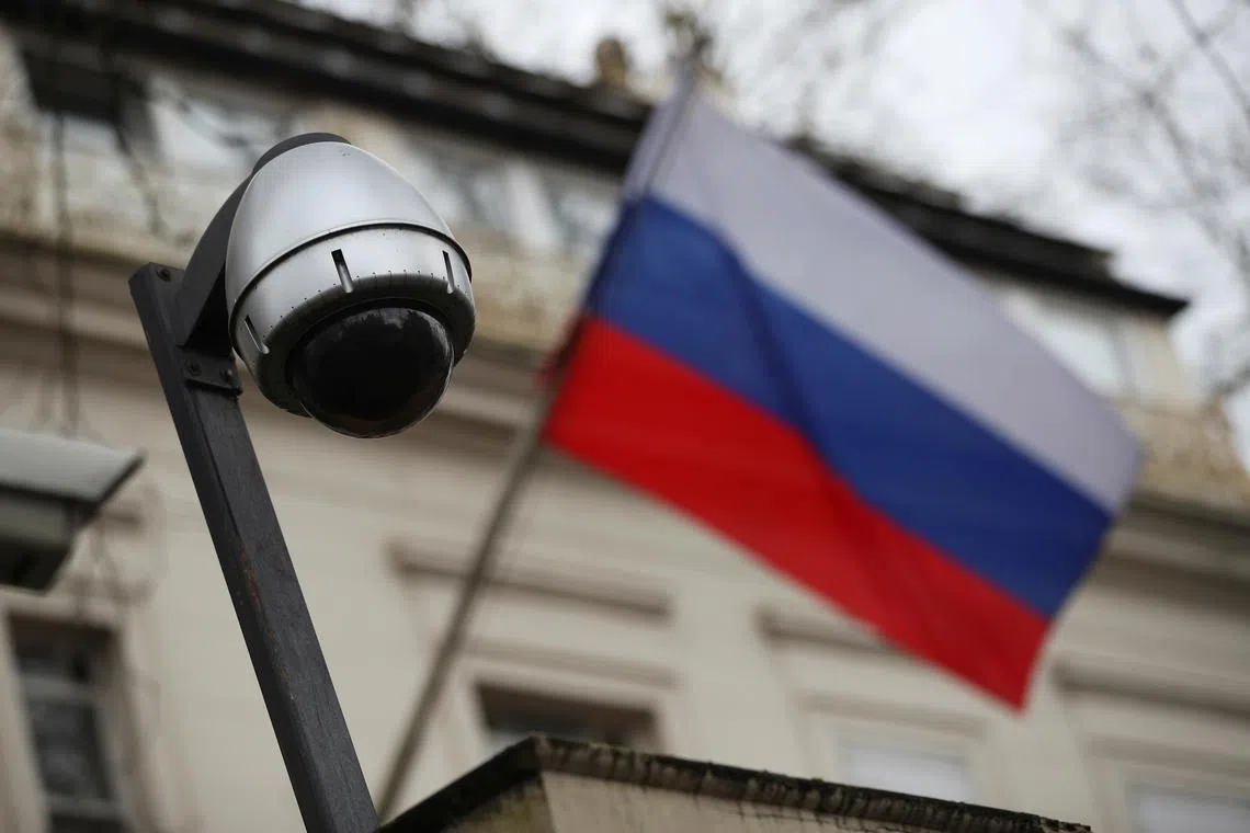 FILE PHOTO: A security camera is seen, and a flag flies outside the consular section of Russia's embassy in London, Britain, March 15, 2018. REUTERS/Hannah McKay/File Photo