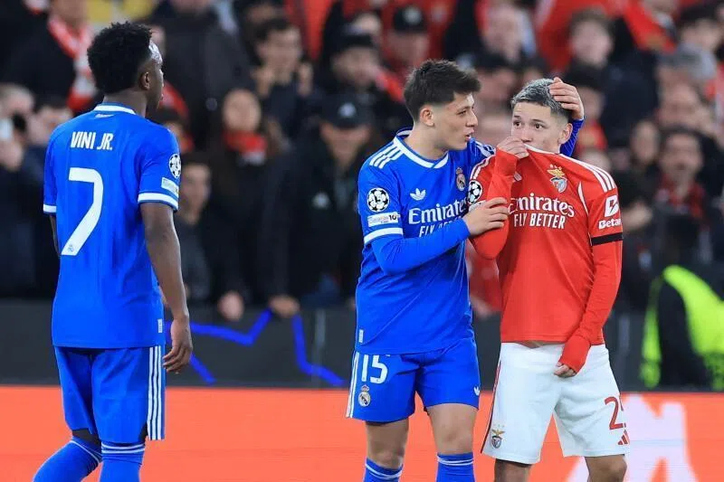 Benfica's Argentine forward Gianluca Prestianni covering his mouth while arguing with Real Madrid's Brazilian forward Vinicius Junior who complained about alleged racists insults during the UEFA Champions League match on Feb 17, 2026.
